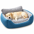 Dog resting on a blue and gray pet bed in a cozy room.